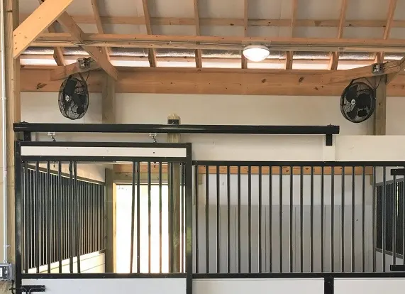 Electric fans in a hors stable to keep horses cool in summer