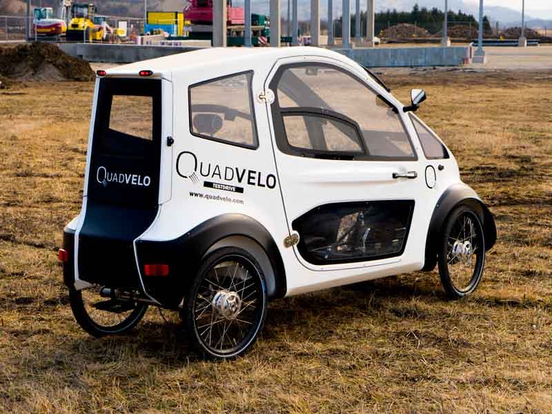 The Quadvelo measures 250 cm long by 84 cm wide by 133 cm high (98.4 by 33 by 52.3 in), and is claimed to tip the scales at 95 kg (209 lb) doors and battery included