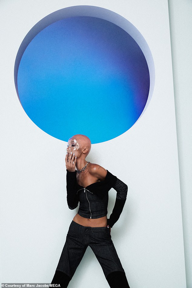Intriguing: Another shot shows her striking a pose in front of a blue wall mural