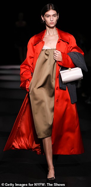 Lady in red: One of the models at the show wore a bright red trench coat on top of a brown dress