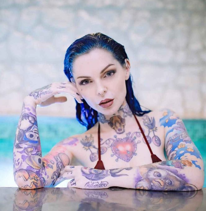 Explore the unique beauty of Riae's tattoos and be mesmerized by her captivating body art! - amazingtoday.net