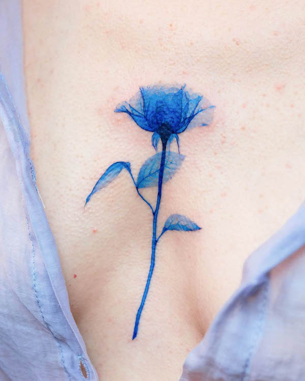 Blue rose between the boobs tattoo by @pokhy_tattoo 1