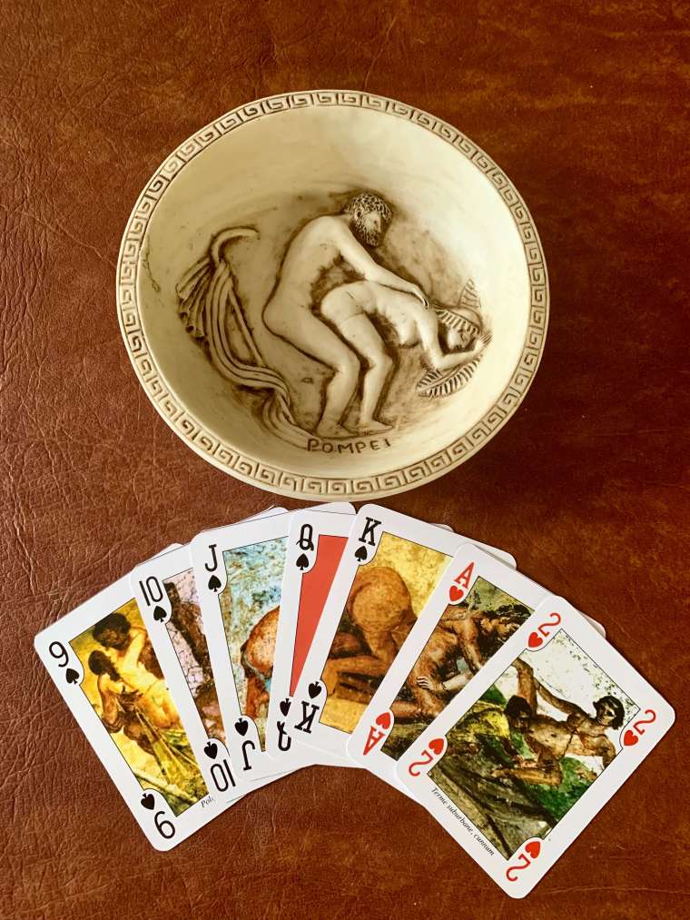 The brothel painting souvenirs I brought home from Pompeii: a carved bowl, and playing cards with Pompeii brothel paintings!