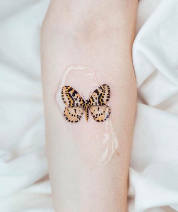 Tiger print butterfly tattoo by @pokhy_tattoo