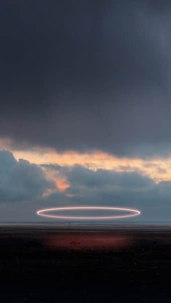 A fleet of disc shaped UFOs hides among the clouds in the sky over the Russian River