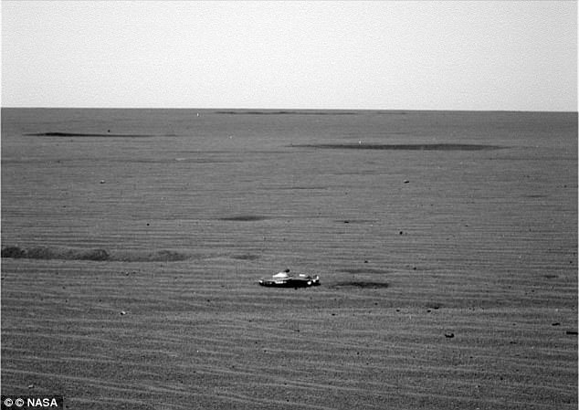The high-definition image appears to show the object glinting against Mars' rocky landscape. While many people believe that the object is made by aliens, others have suggested that it is merely the rover's own entry debris