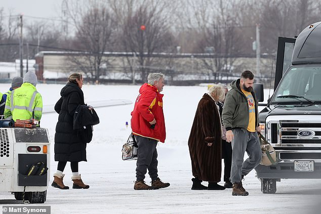 Jason Kelce, wife Kaylie (far left in black) and Ed Kelce are seen making their way to the van