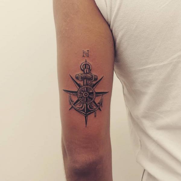 Anchor and wheel back of arm tattoo