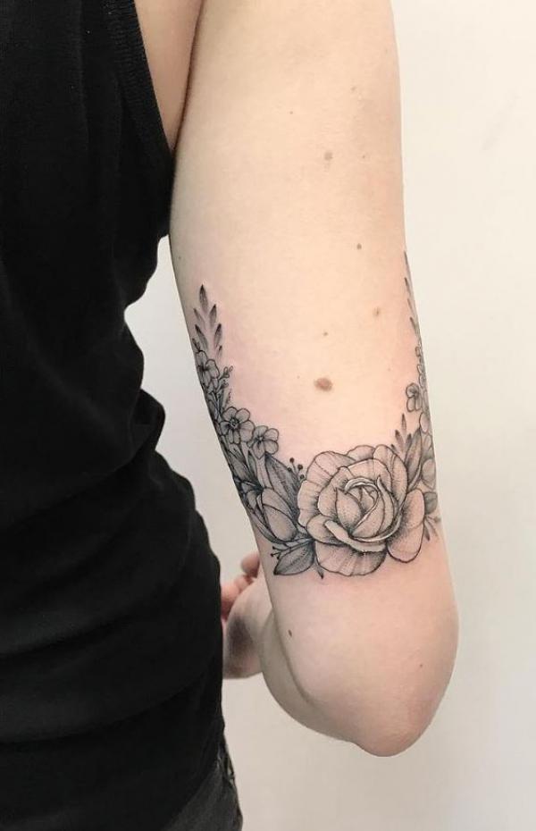 Black and grey peony back of arm tattoo