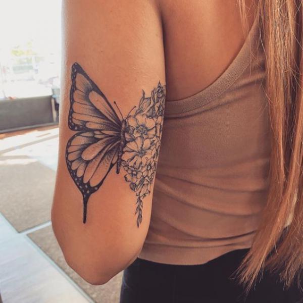 Half butterfly and half flowers back of arm tattoo