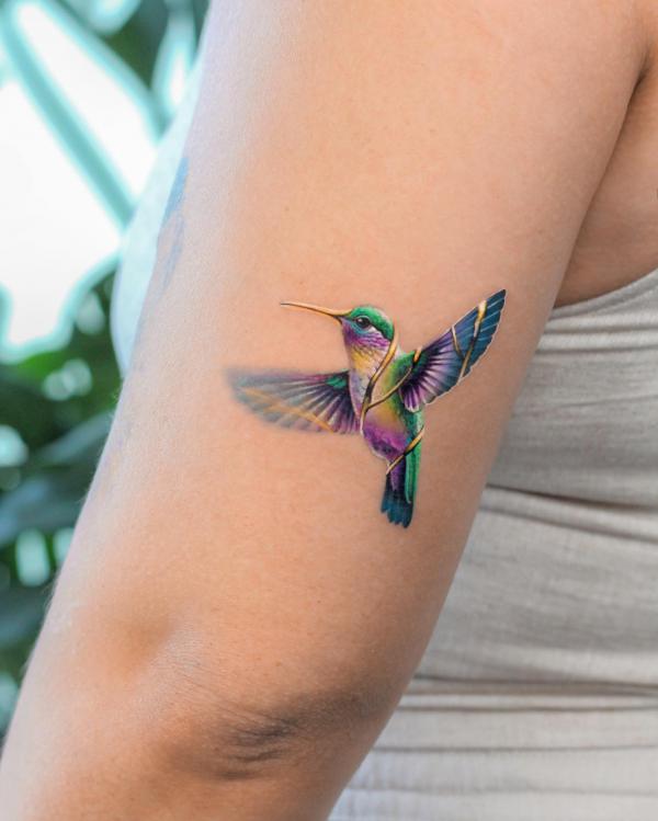 Hummingbird back of arm tattoo