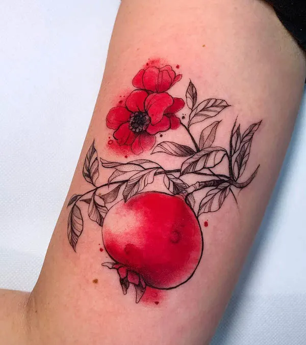 Pomegranate and flower watercolor tattoo by @marta_atzeni_tattoo