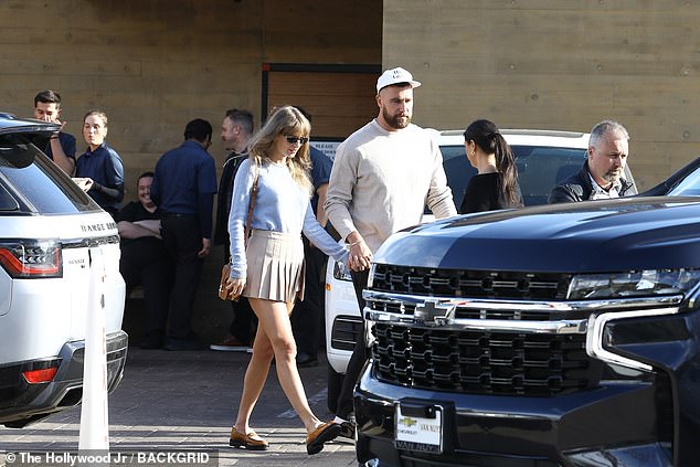 The singer had a baby blue sweater tucked into her skirt, adding a pop of color to her date outfit