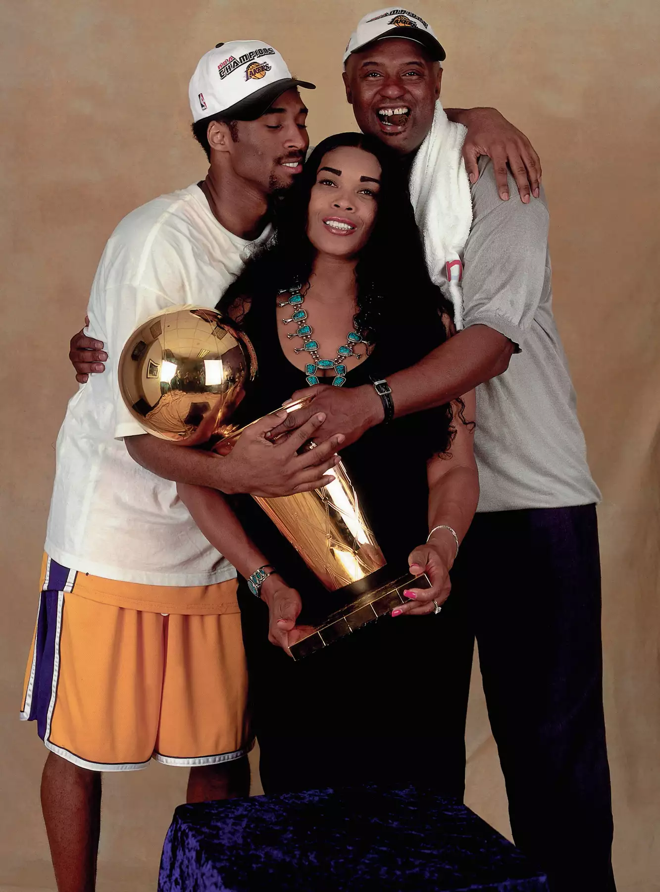 Kobe Bryant #8 of the Los Angeles Lakers poses for a photo with his parents after winning the NBA Championship on June 19, 2000