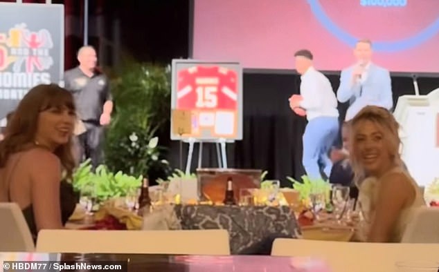 Swift shared a table with Patrick's wife Brittany Mahomes (R) and the ladies looked amused as the 28-year-old Kansas City Chiefs (M) launched a football over the heads of the black-tie crowd