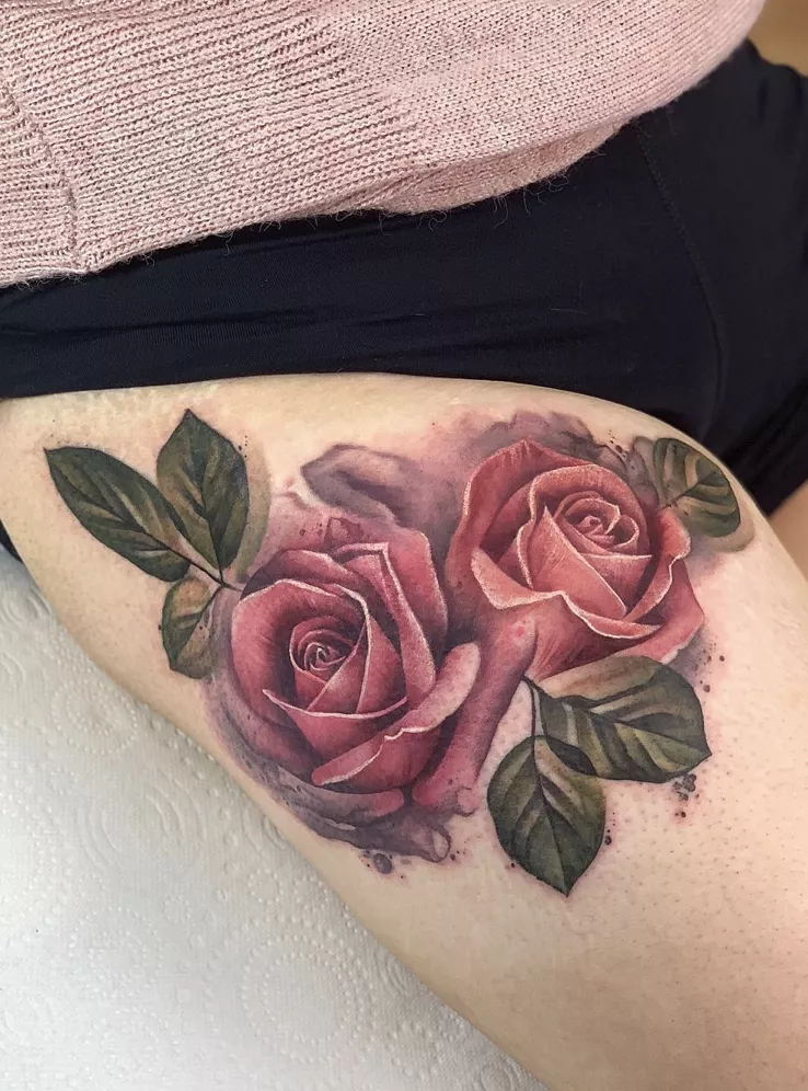 rose tattoo on thigh