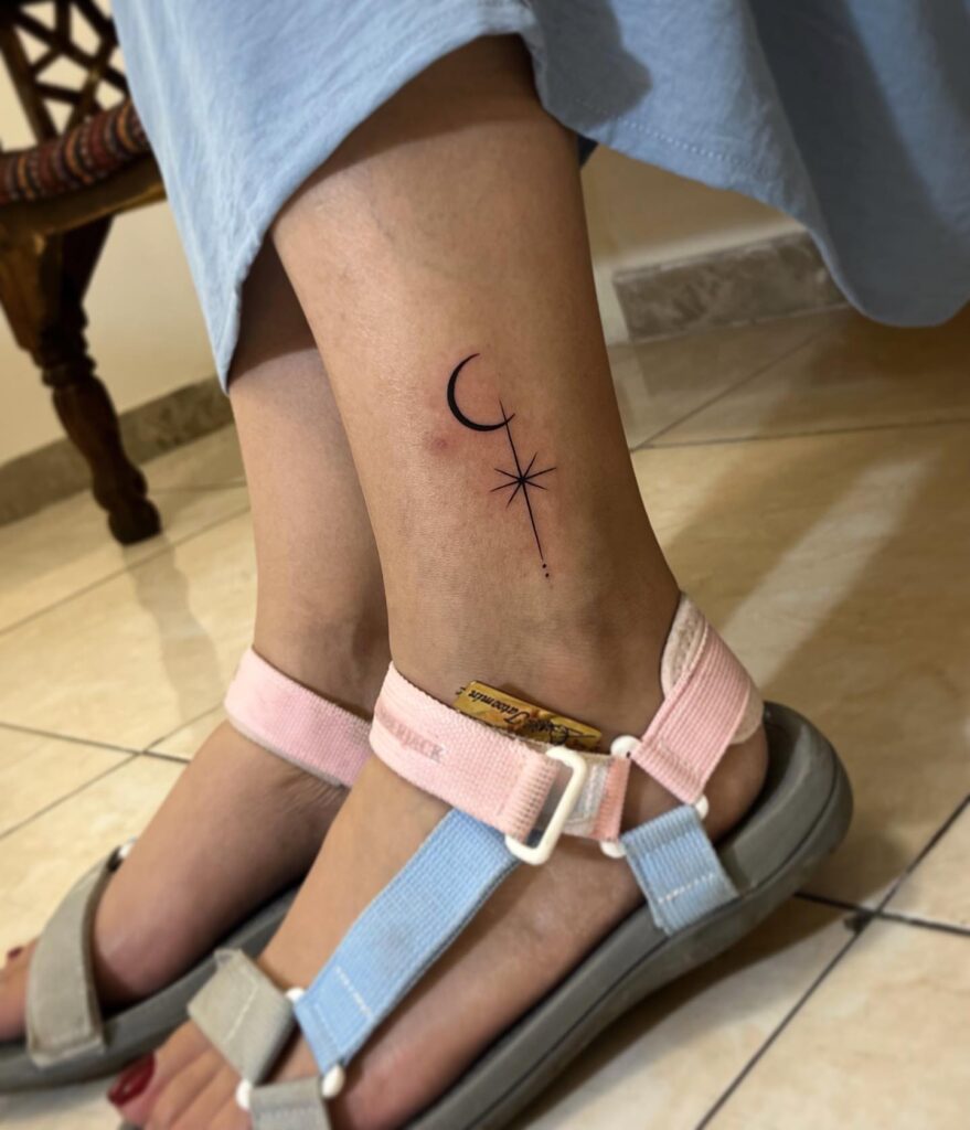 Minimalistic moon and stars tattoo above the ankle
