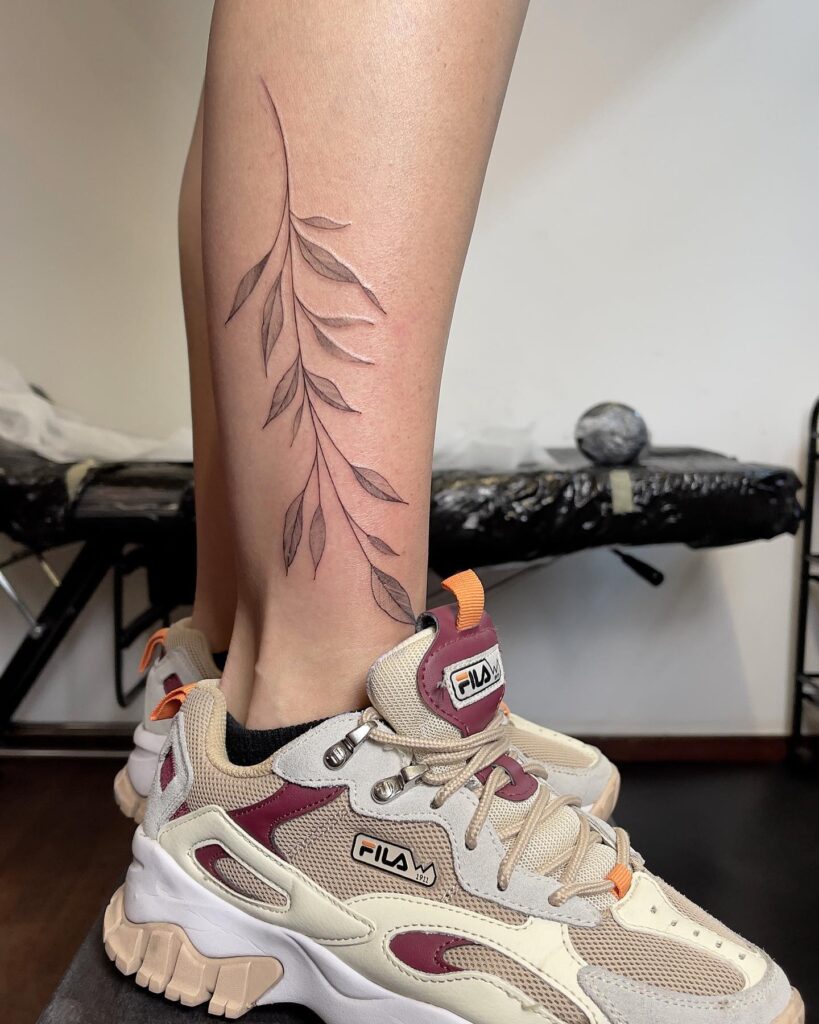 Dainty willow branch tattoo leg for girls

