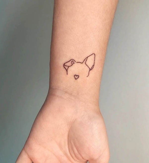 Dog ear outline wrist tattoo by @karinemelotattoo