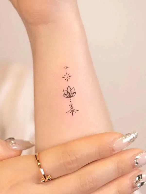 Small lotus tattoo by @handitrip