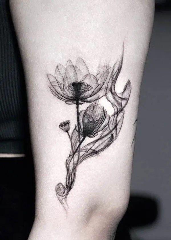 Flowy black lotus tattoo by @e.bin_ink