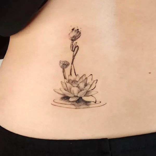 Black floating lotus tattoo by @choiwoo.tattoo