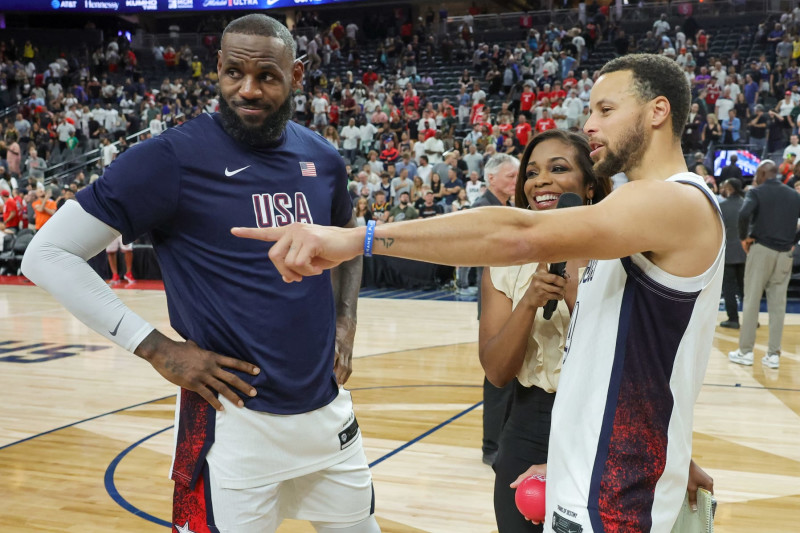 LAS VEGAS, NEVADA - JULY 10: LeBron James (L) #6 and Stephen Curry #4 of the United States are interviewed on the court by Kristina Pink of Fox Sports after the team's 86-72 victory over Canada in their exhibition game ahead of the Paris Olympic Games at T-Mobile Arena on July 10, 2024 in Las Vegas, Nevada. (Photo by Ethan Miller/Getty Images)