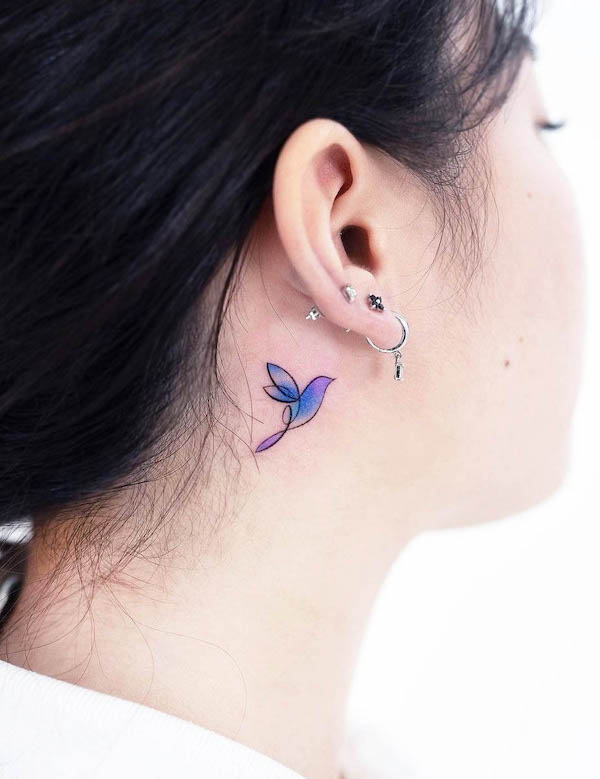 Tiny bird behind the ear tattoo by @foret_tattoo