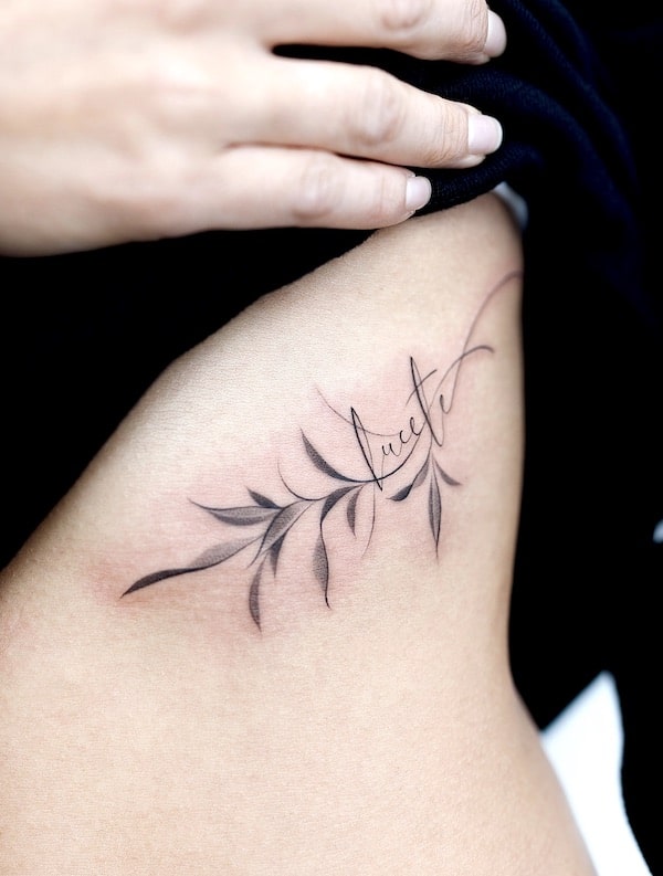 Leaves and script tattoo by @foret_tattoo