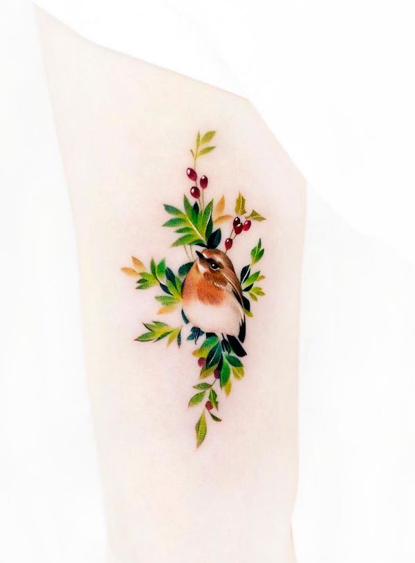 Vibrant bird and plants tattoo by @foret_tattoo