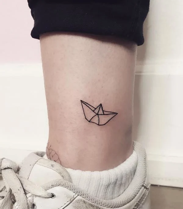 Paper boat ankle tattoo by @beaume_tattoo