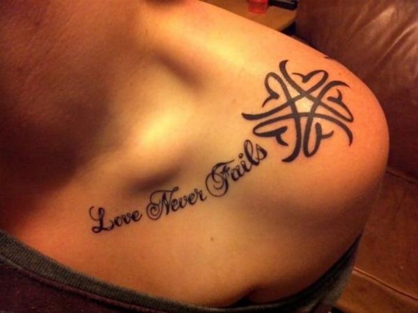 Love never fails lettering tattoo on clavicle