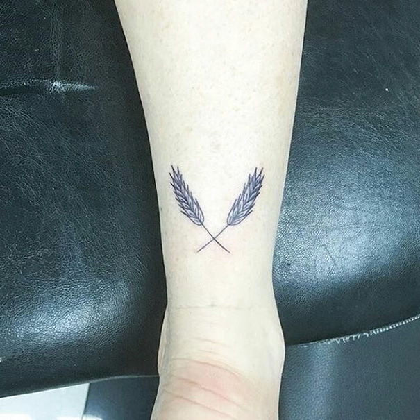 Two crossed wheat tattoo