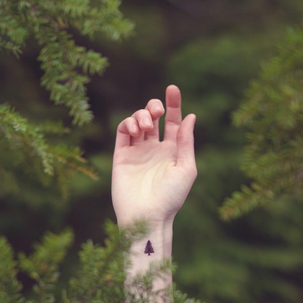 Black small pine tree wrist tattoo