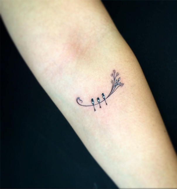 Three birds on branch delicate arm tattoo