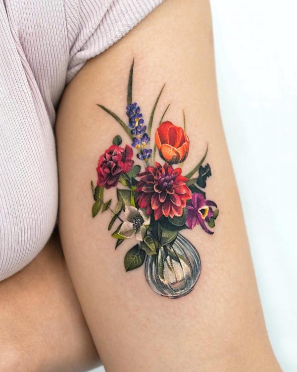 A bouquet of poppy dahlia hydrangea in bottle tattoo