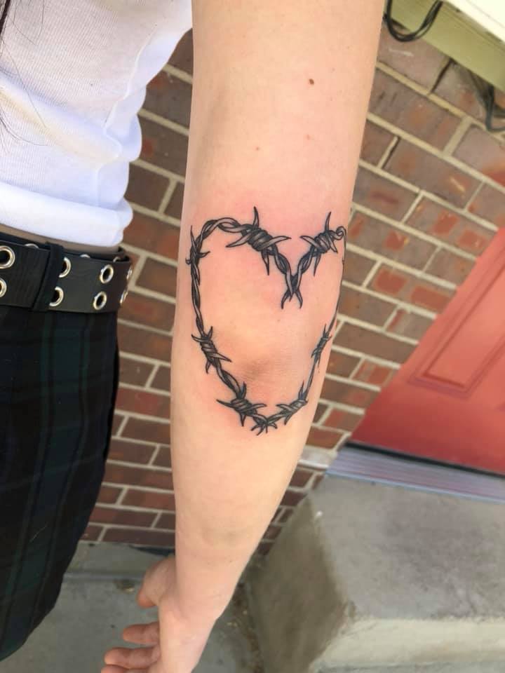 Barbed wire heart tattoo elbow