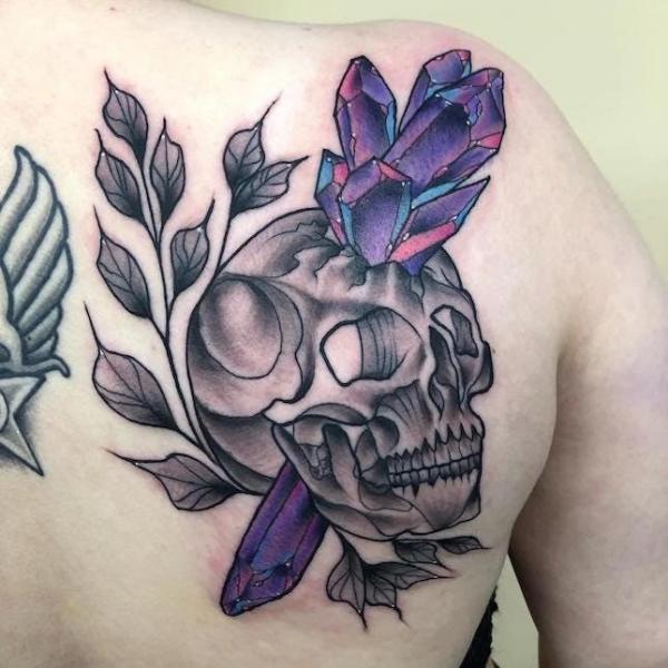 Crystal and skull tattoo on shoulder blade