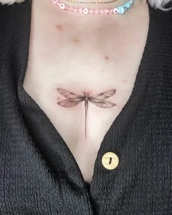 Dragonfly tattoo between boobs by @colette.ink_