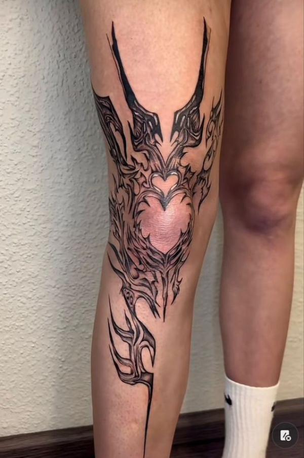 Knee cyber sigilism with heart tattoo