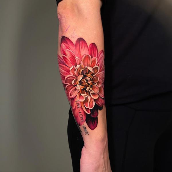 Pink dahlia tattoo with words live love unite