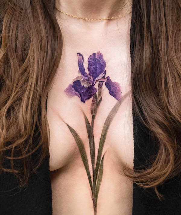 Purple flower cover up tattoo by @chenjie.newtattoo