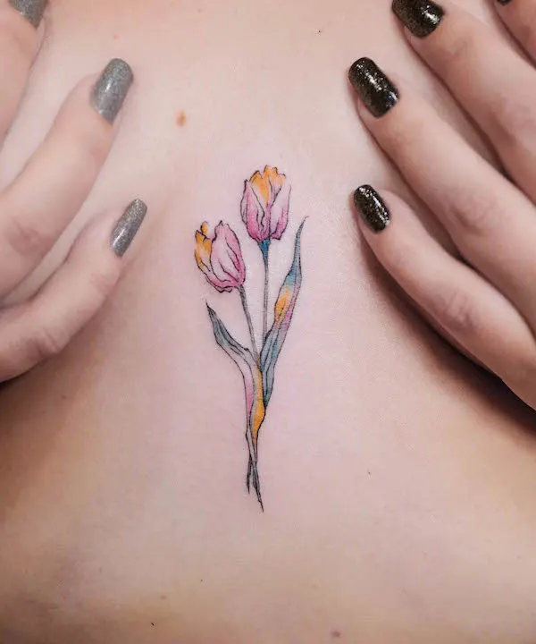 Rainbow tulip tattoo between boobs by @jessieke_