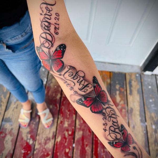 Red butterfly sleeve tattoo with names and dates