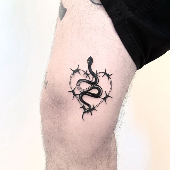 Snake in barbed wire heart tattoo