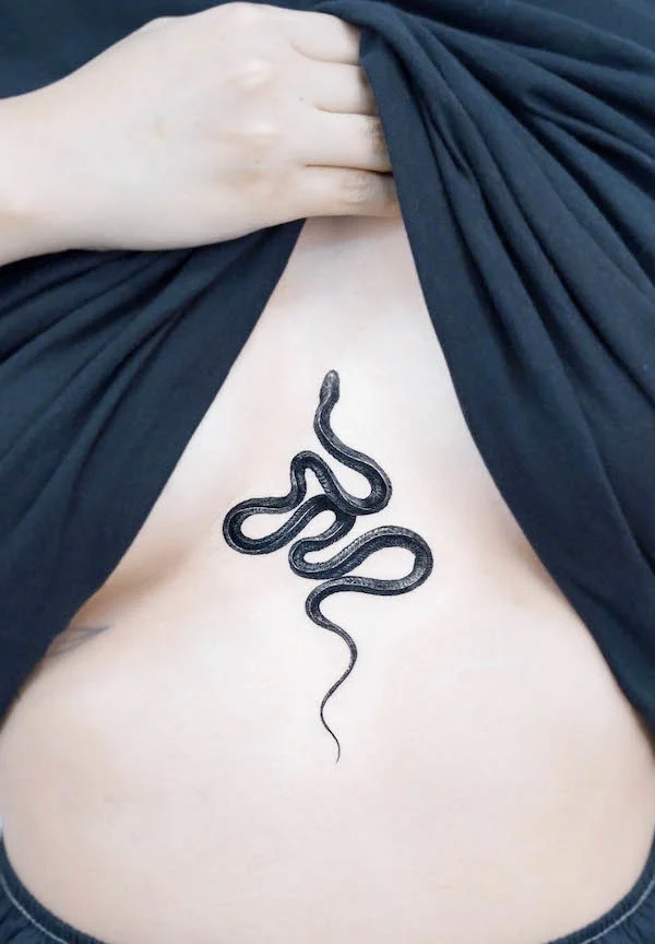 Snake tattoo between boobs by @stuffie.ink_