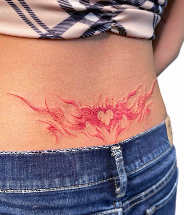 Burning heart waist tattoo by @uzotattoo