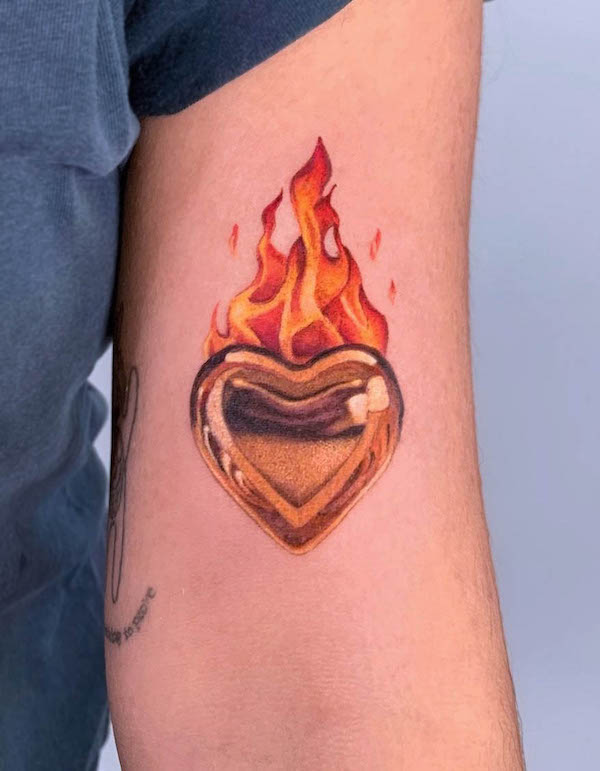 Golden heart on fire tattoo by @julie_agnes