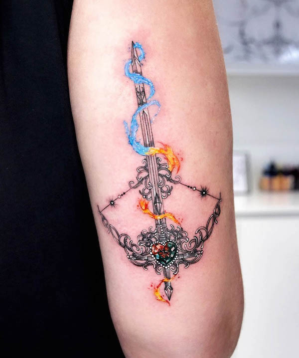 Water and fire bow and arrow tattoo by @munsell_tattoo