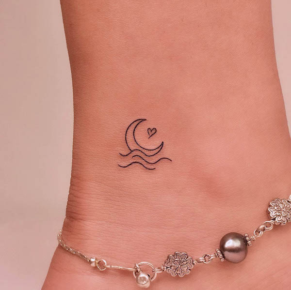 Tiny moon and wave ankle tattoo by @tattooer_jina